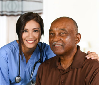 a female caregiver smiling with an elderly man